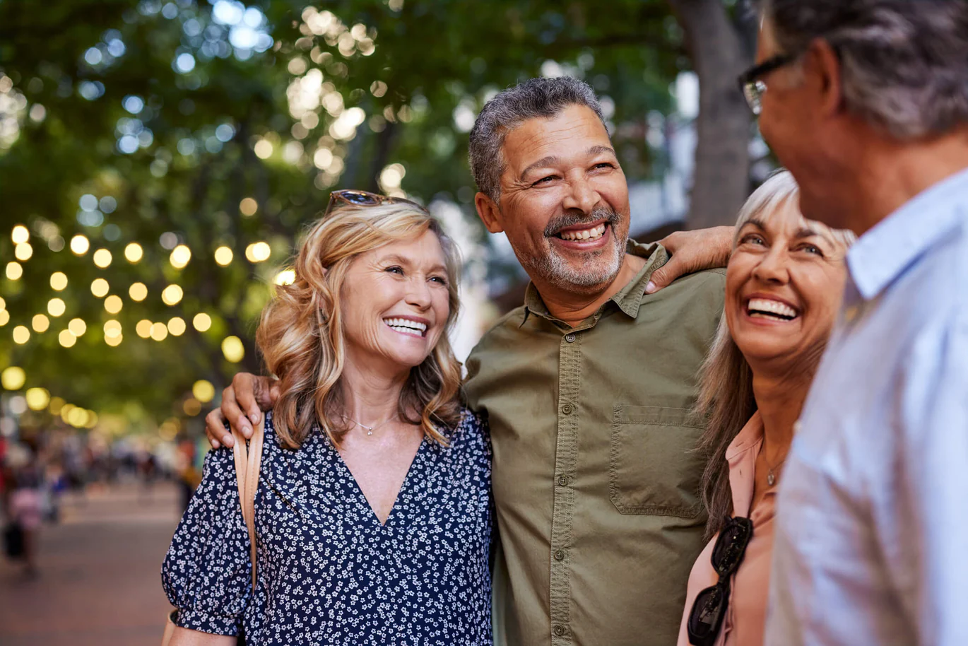 Group of diverse adults laughing together in the city