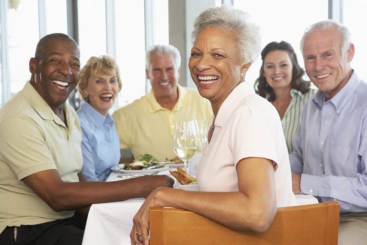 Group of diverse adults laughing and socializing together